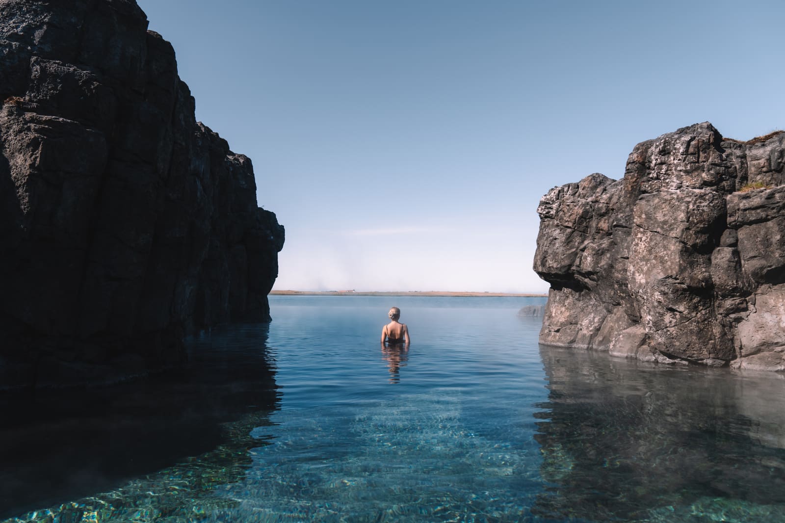 People soaking in a geothermal lagoon beside the ocean near Reykjavik