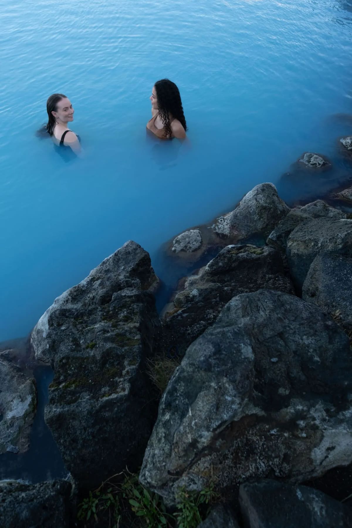 People soaking in geothermal lagoon water at Earth Lagoon Mývatn