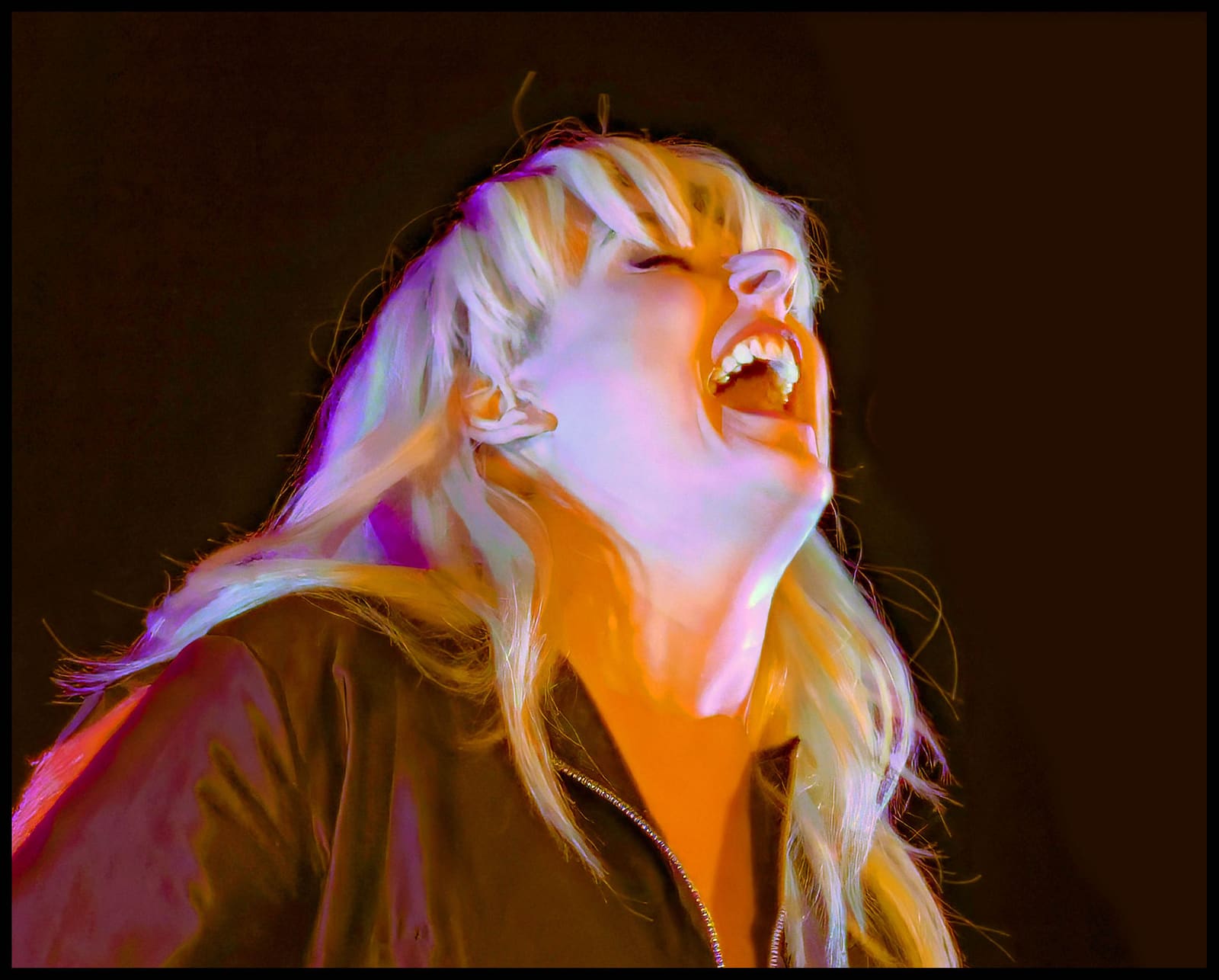 Eivør singing under warm stage lights at Iceland Airwaves in 2018