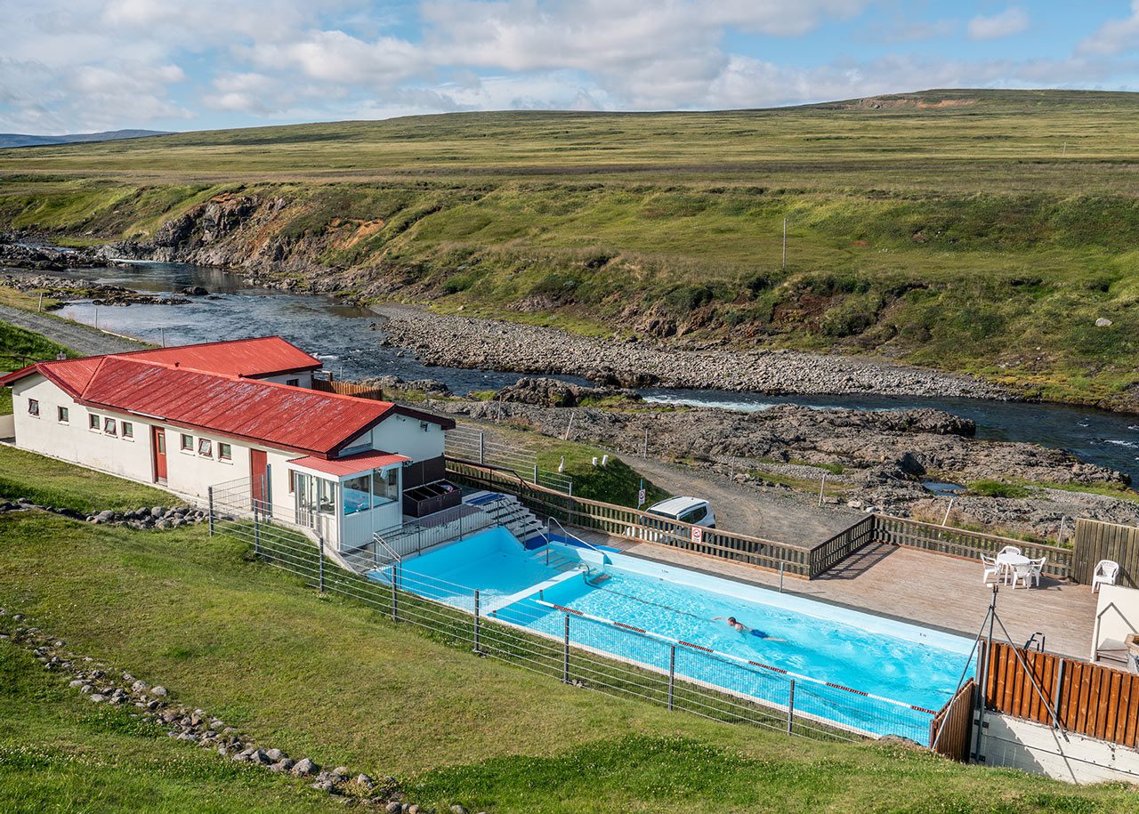 Selárdalslaug swimming pool beside a river in the open Vopnafjörður landscape