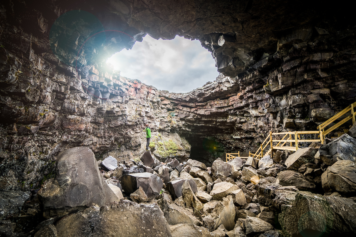 Wooden stairs and boulders at the daylight entrance to Víðgelmir lava cave