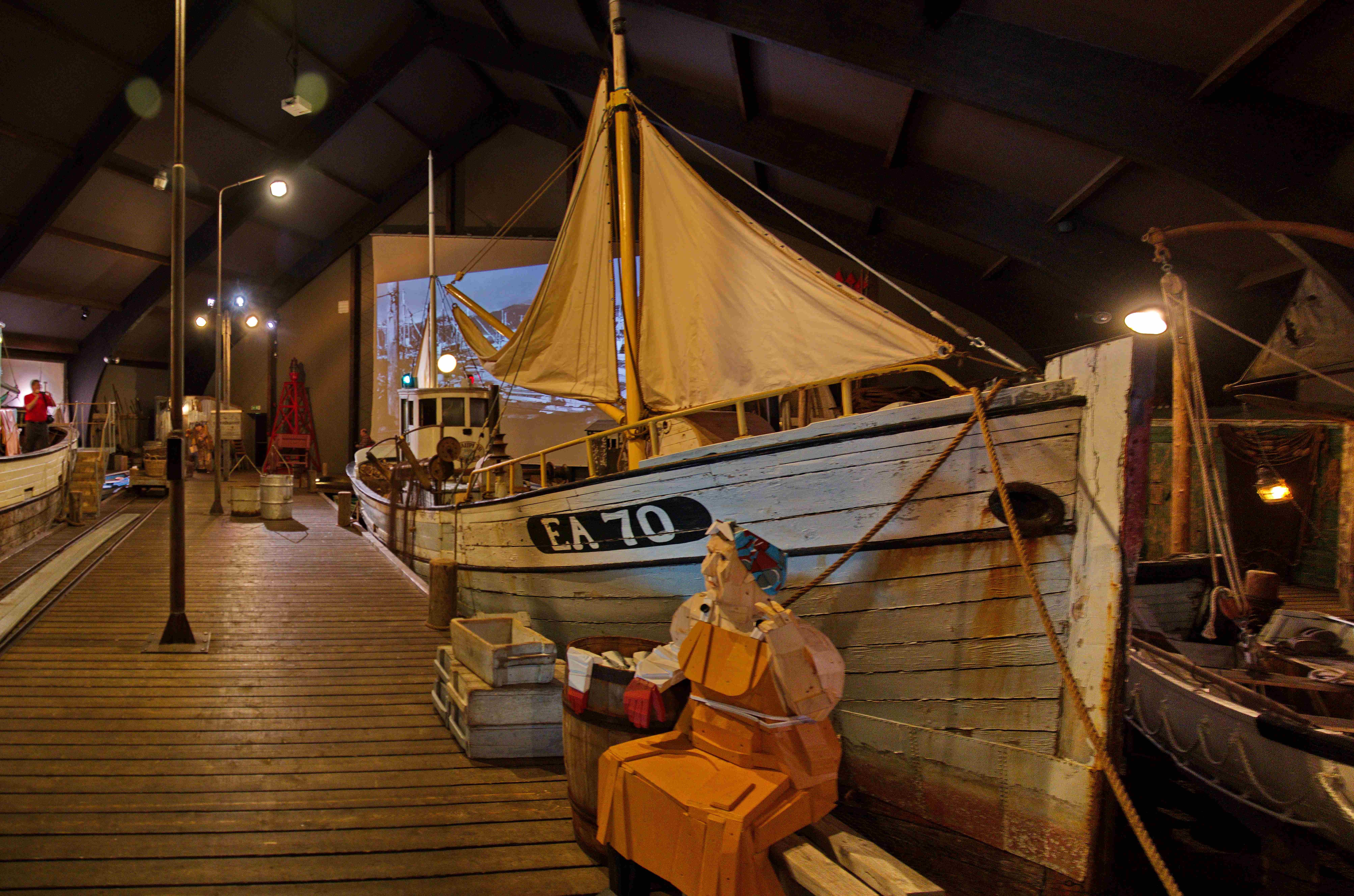 Historic fishing boat displayed inside the Herring Era Museum in Siglufjörður