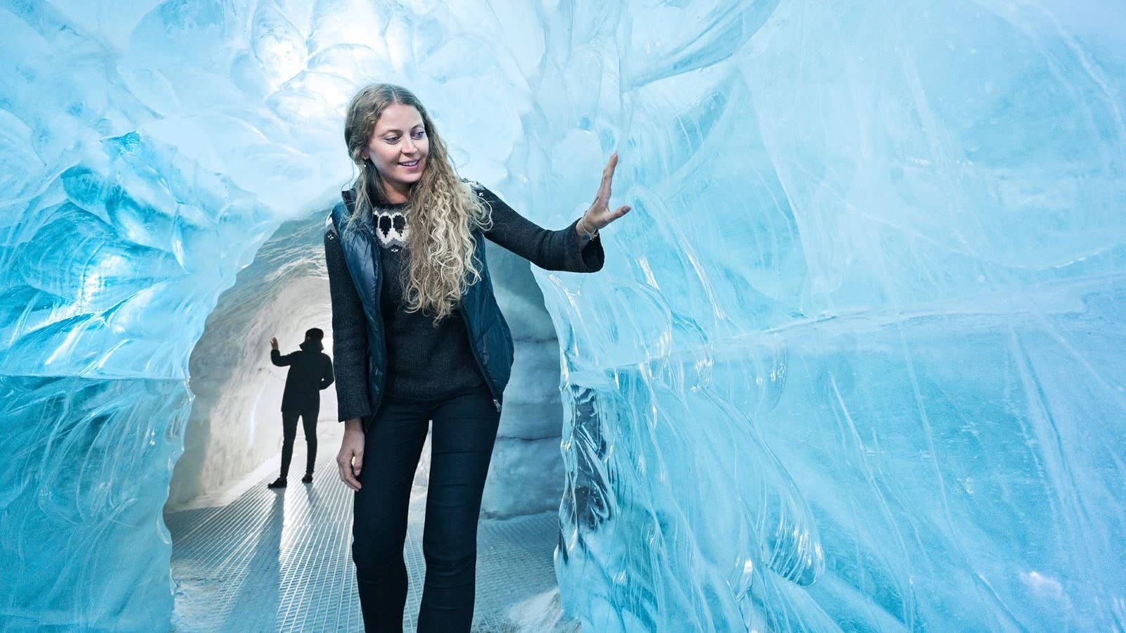 Visitor walking through Perlan's indoor ice feature in Reykjavík