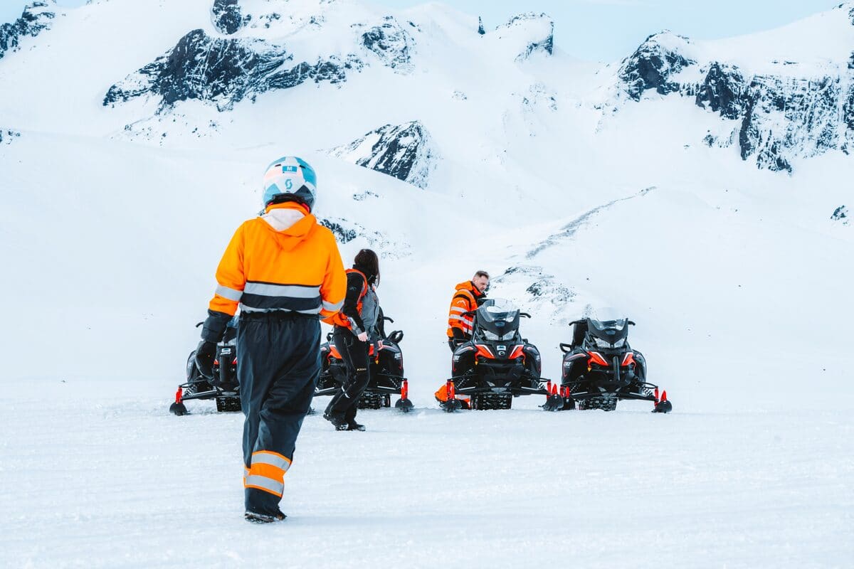 Guided snowmobile group riding across Langjokull glacier in Iceland