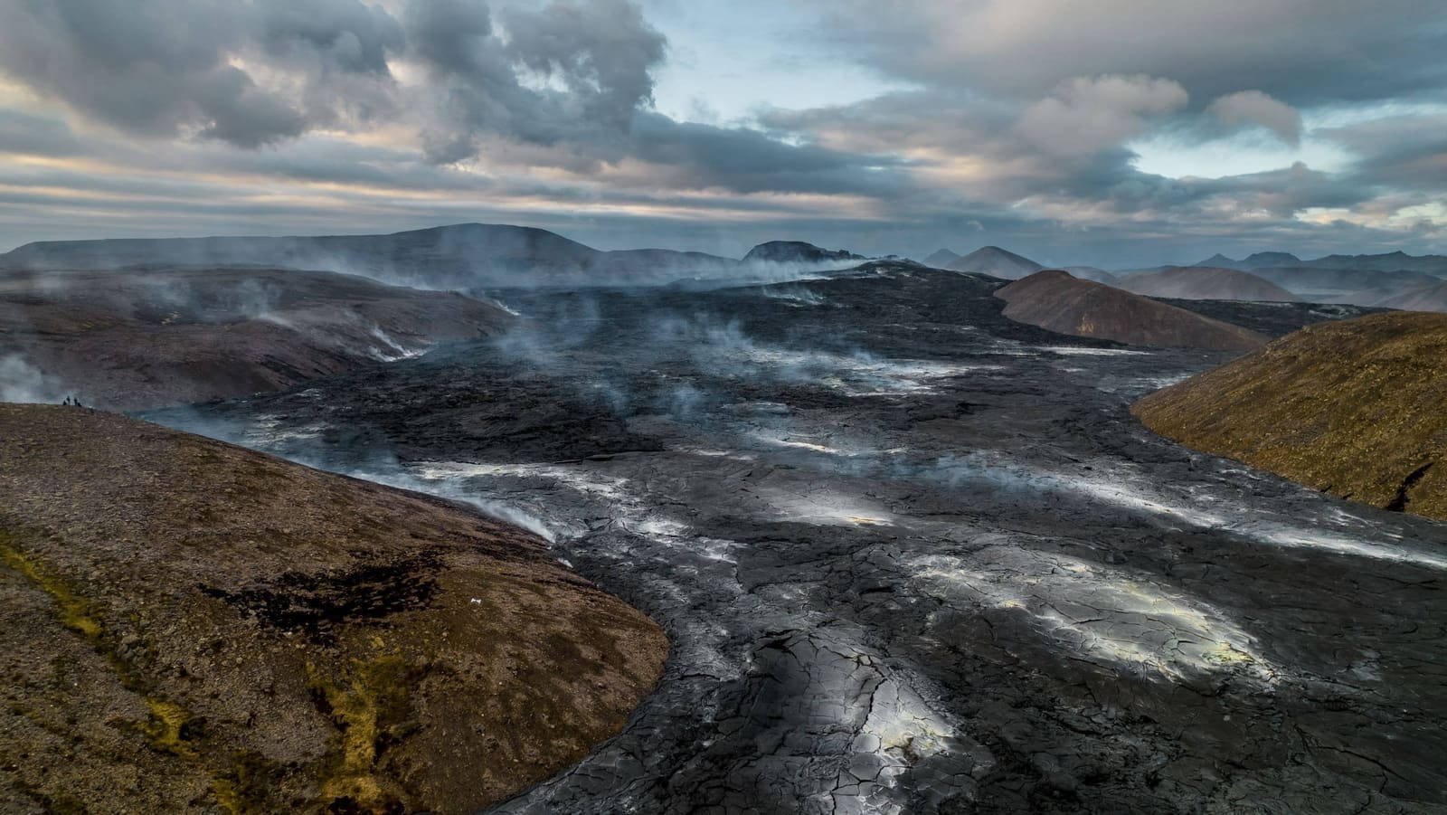 Aerial view of black cooling lava and small steam plumes at Sundhnúkagígar on the Reykjanes Peninsula.