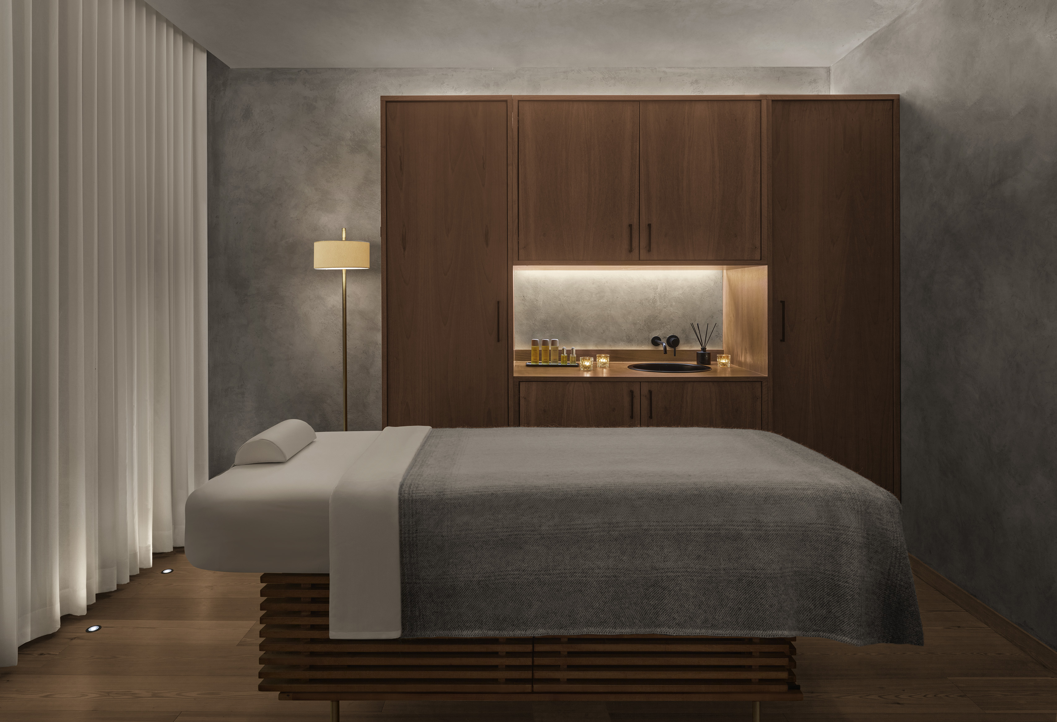 Prepared treatment table and warm wood cabinets inside the Reykjavík EDITION Spa