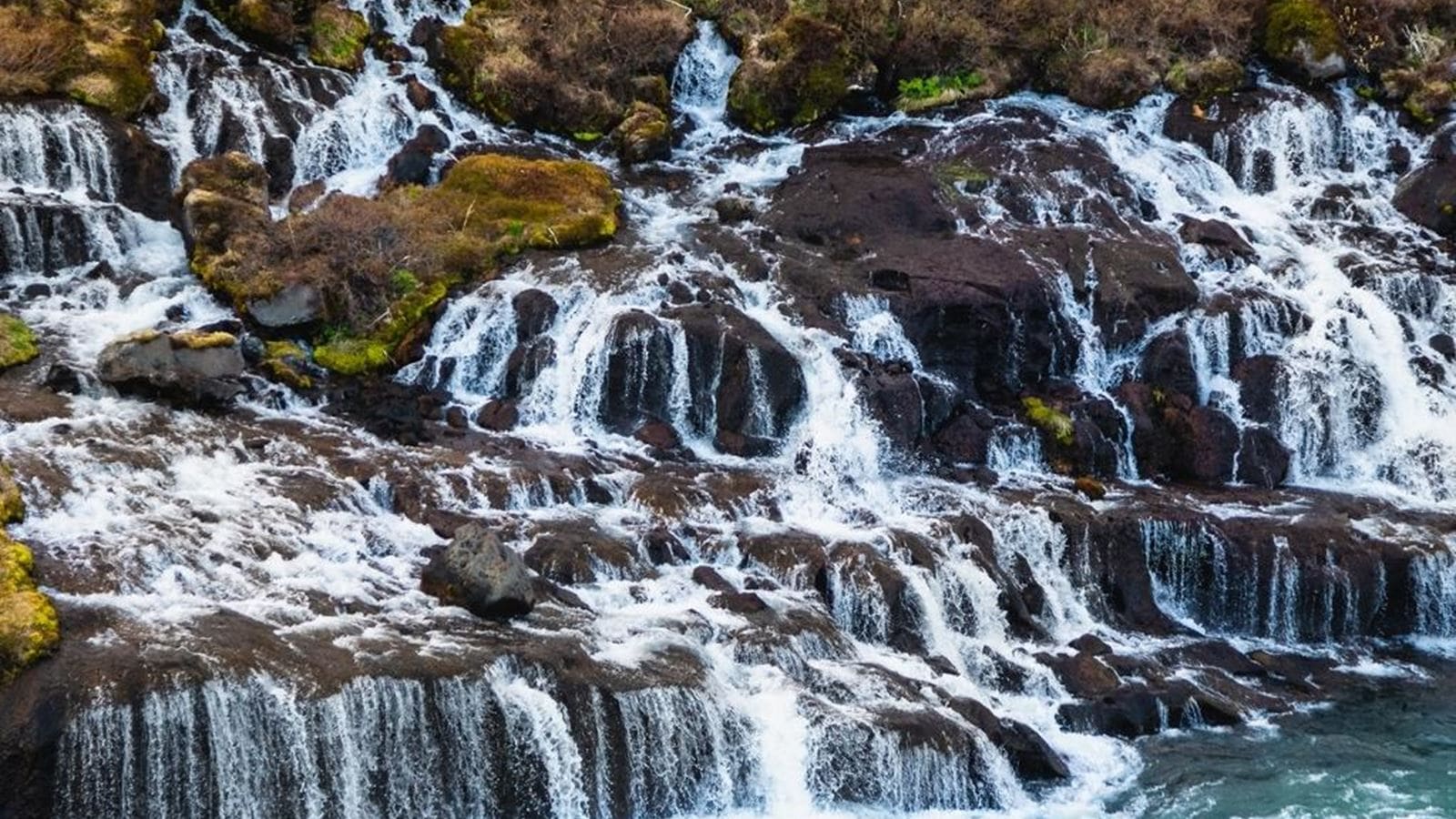 Hraunfossar waterfall in autumn colors during Iceland shoulder season