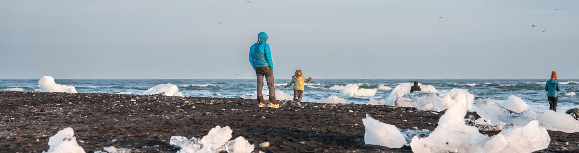 Travelers beside ice on Iceland’s southeast coast during a route decision