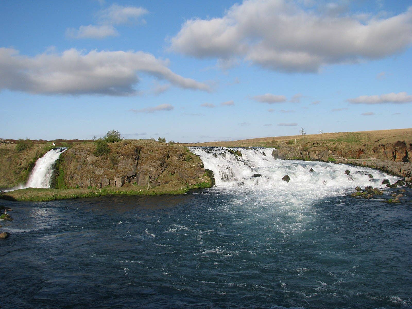 Another Ytri-Rangá waterfall scene showing low South Iceland riverbanks and a broad cascade.