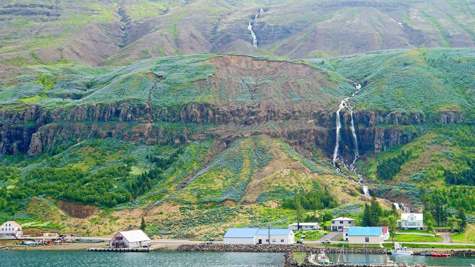 Budareyrarfoss Waterfall cascading down the hillside above Seyðisfjörður in East Iceland.