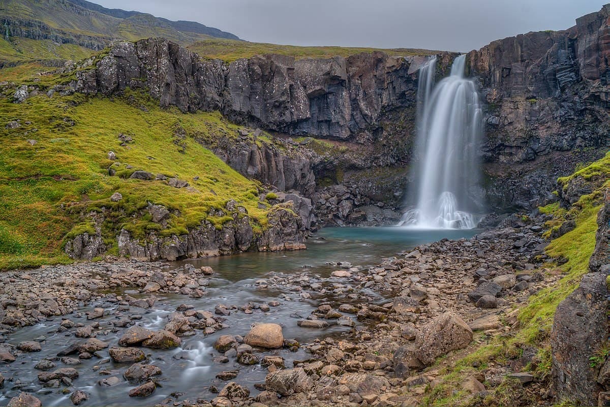 Gufufoss Waterfall near Seyðisfjörður dropping over dark rock in East Iceland.