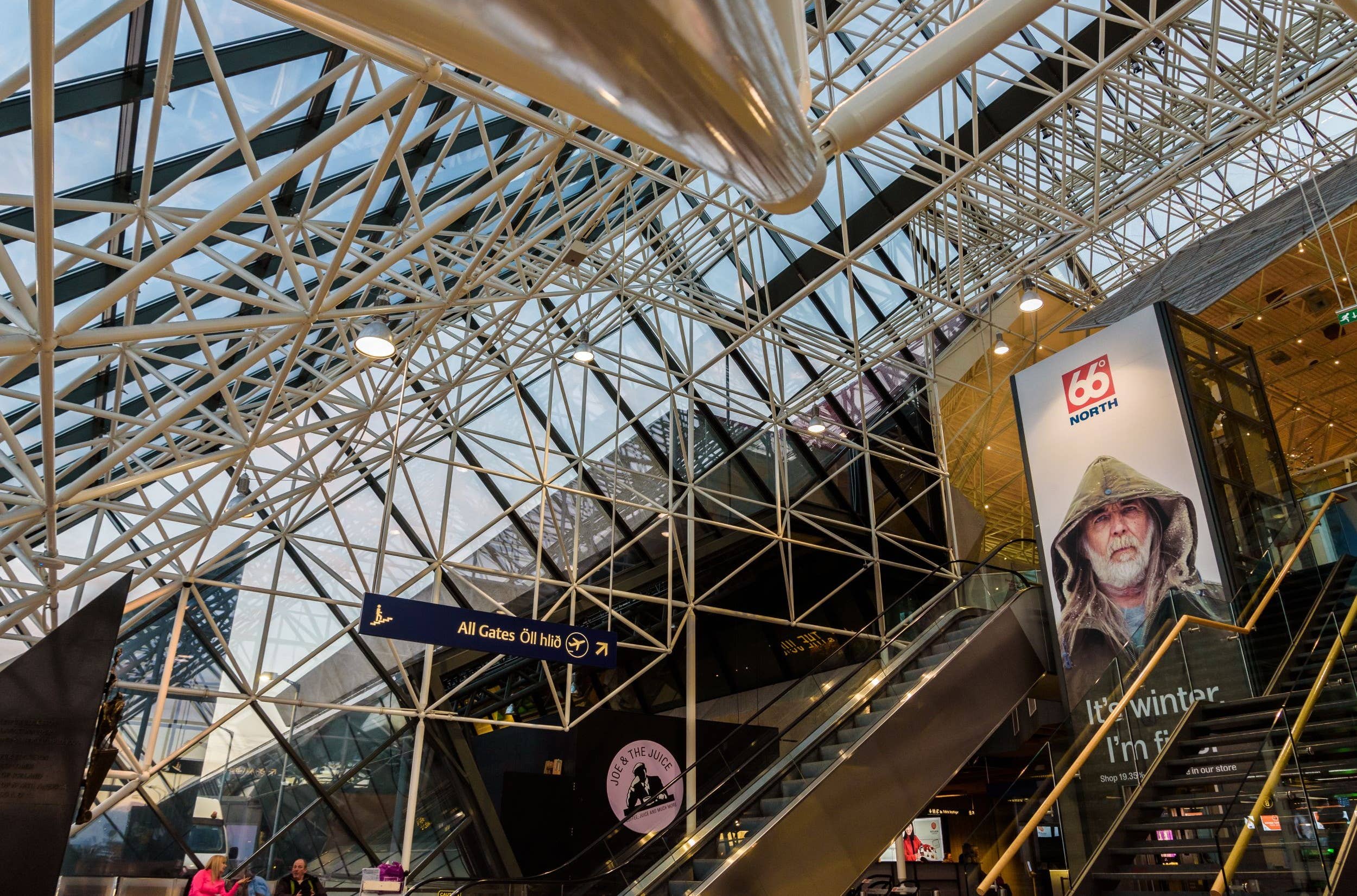 Interior concourse and signs inside Keflavík International Airport.