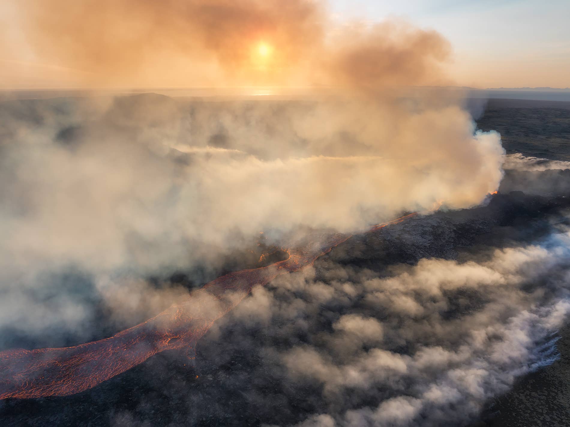 Gas plumes and fresh lava spreading across dark ground near Litli-Hrútur in 2023.