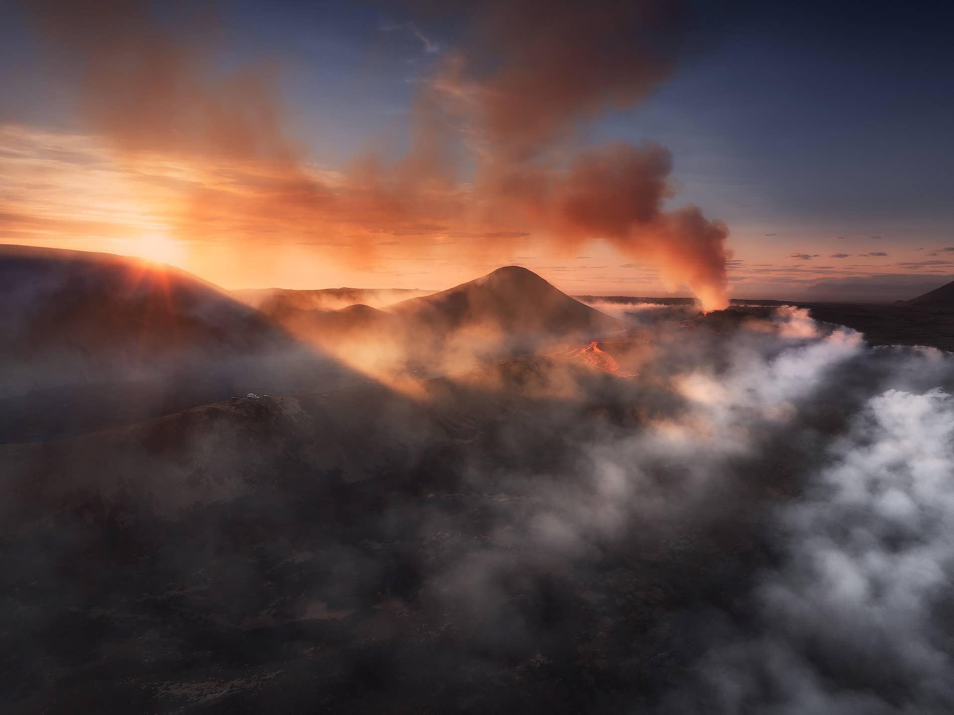 Sunset aerial of lava rivers and volcanic gas around Litli-Hrútur in southwest Iceland.