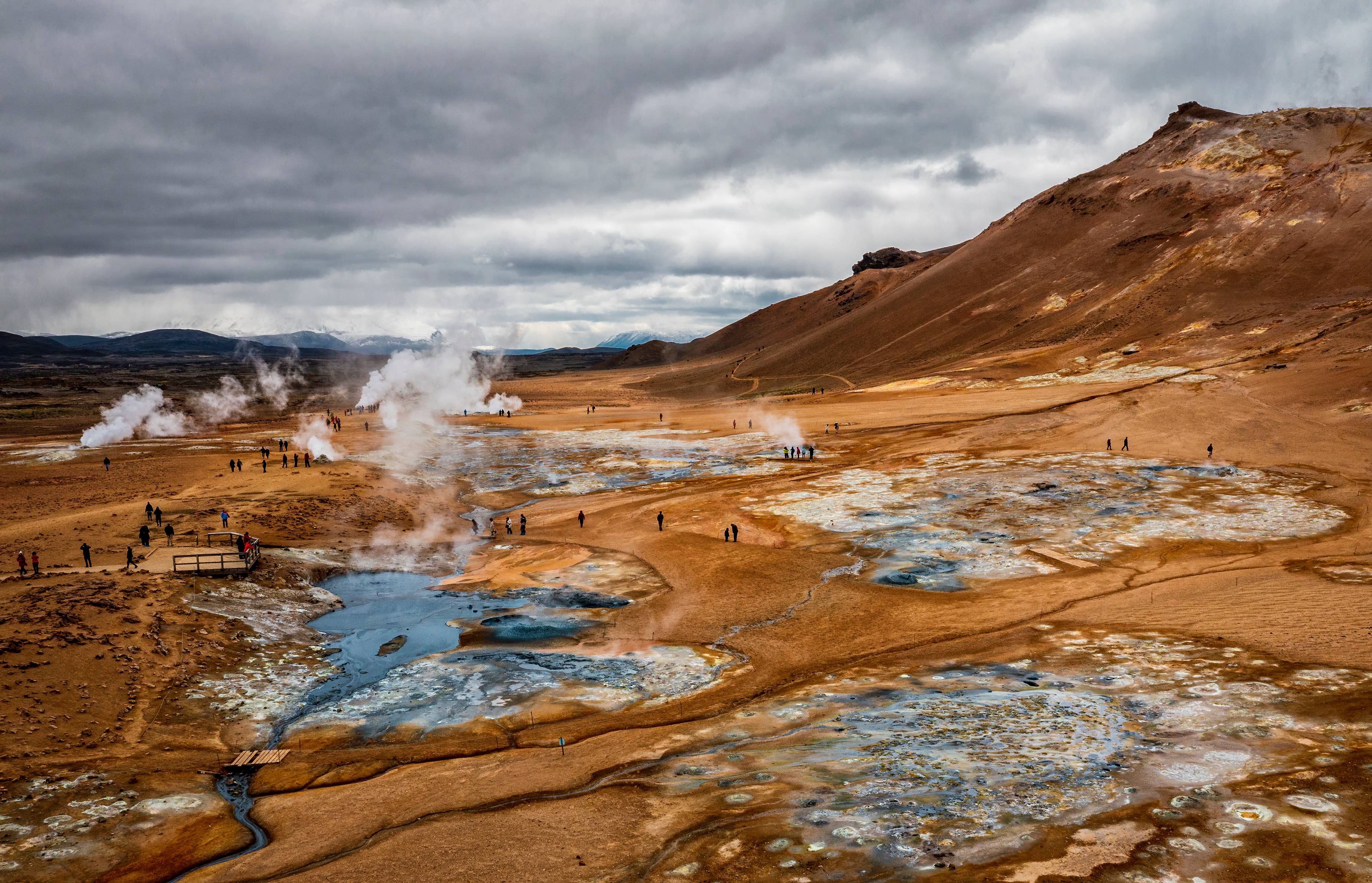 Visitors walking through the Námafjall and Hverir geothermal area near Lake Mývatn.