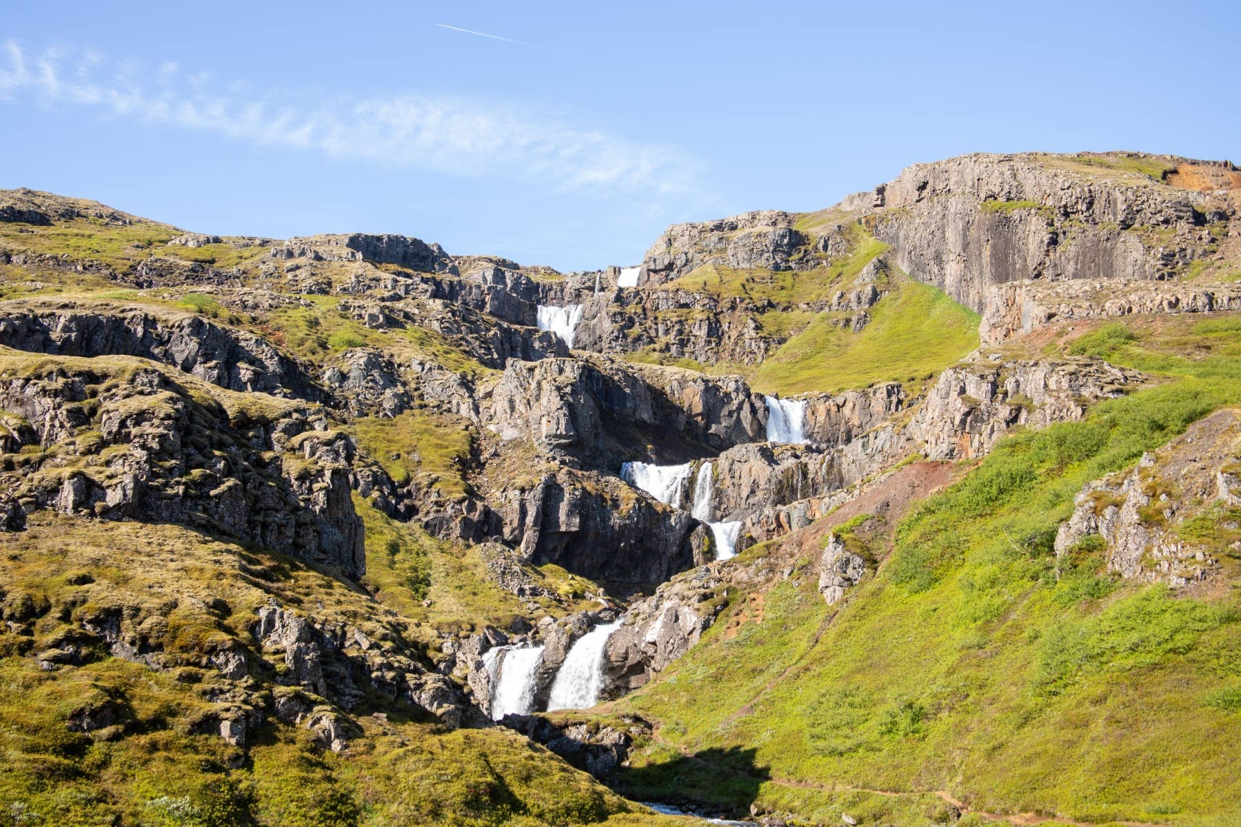 A tiered waterfall on the slopes around Seyðisfjörður showing the kind of terrain near Vestdalsfossar.