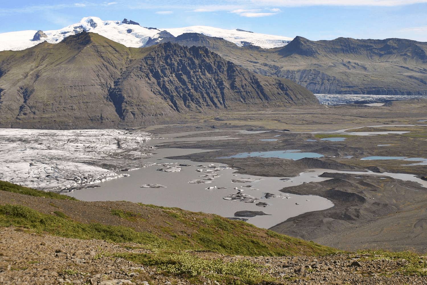 Traveler looking over Skaftafellsjökull from Sjónarnípa viewpoint in Skaftafell.