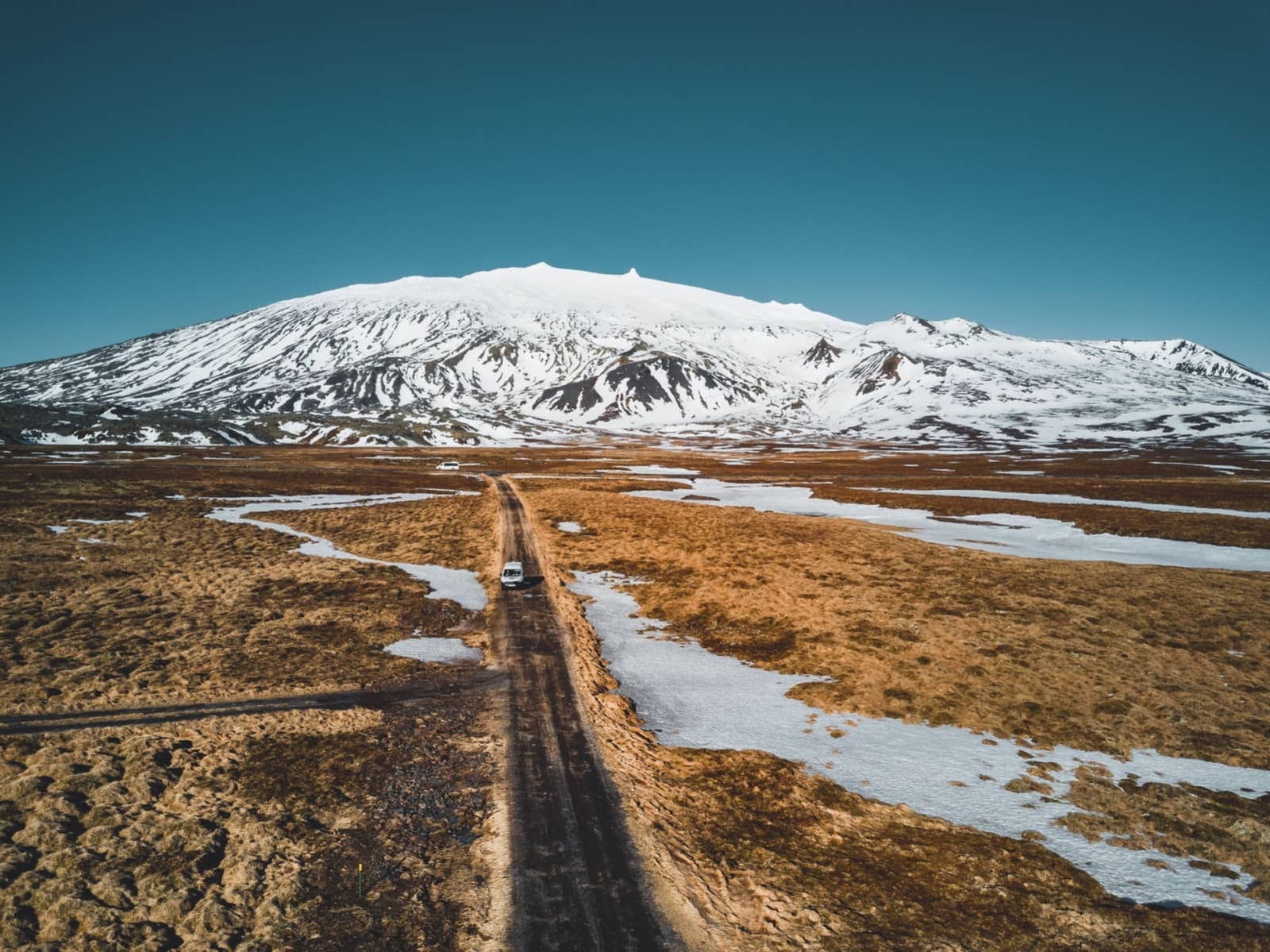 Snæfellsjökull National Park landscape with the glacier-capped volcano, lava fields, and a scenic road on Snæfellsnes.