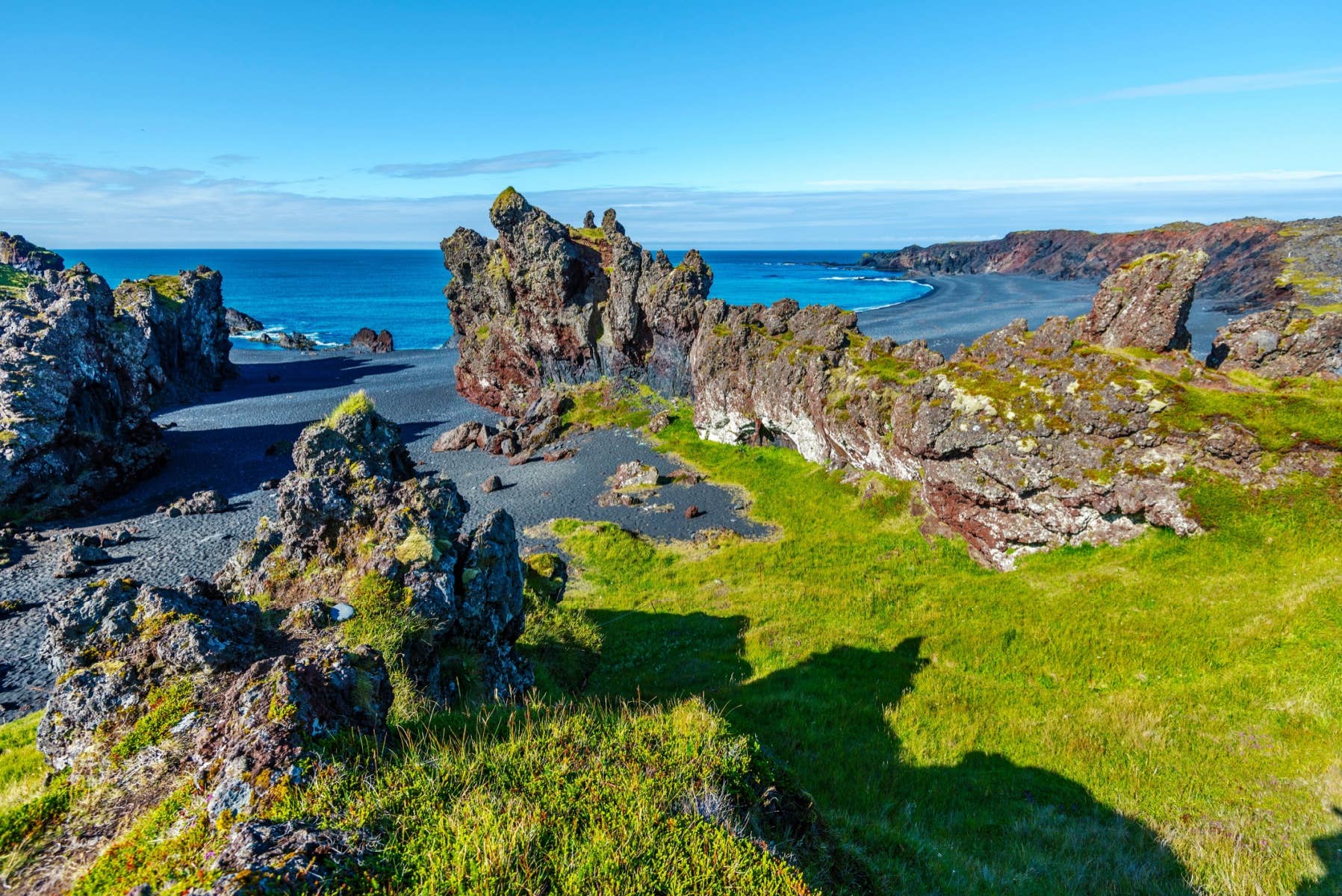 Dark lava cliffs and black beach at Djúpalónssandur in Snæfellsjökull National Park.