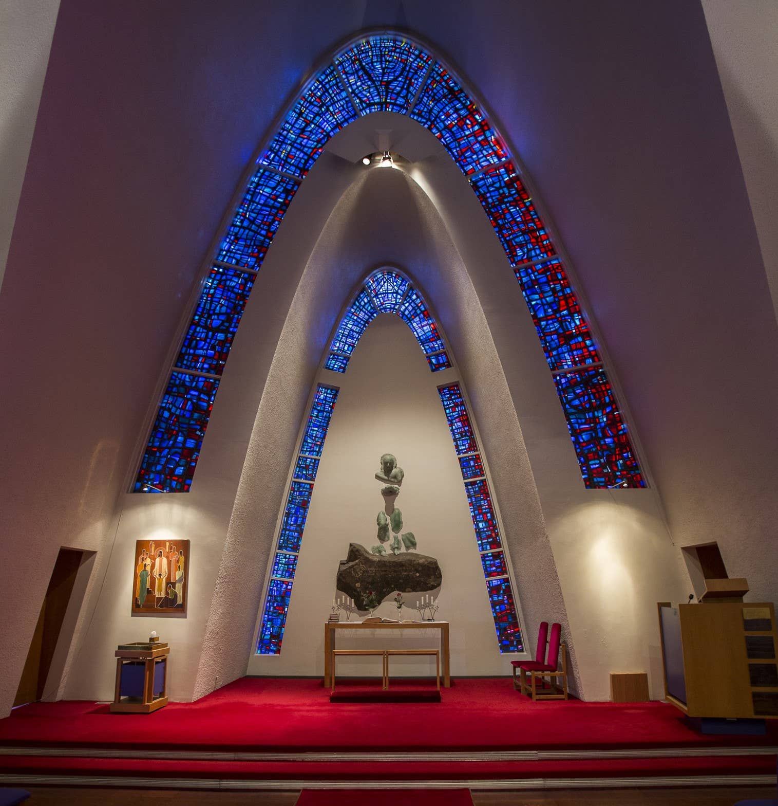 Altar and stained-glass arches inside Kópavogskirkja Church.