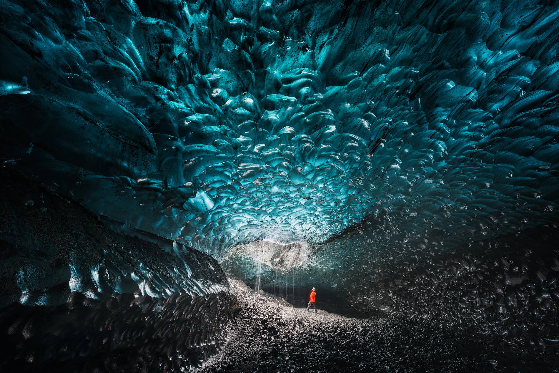 Bright blue ice formations inside Crystal Ice Cave showing changing natural cave shapes