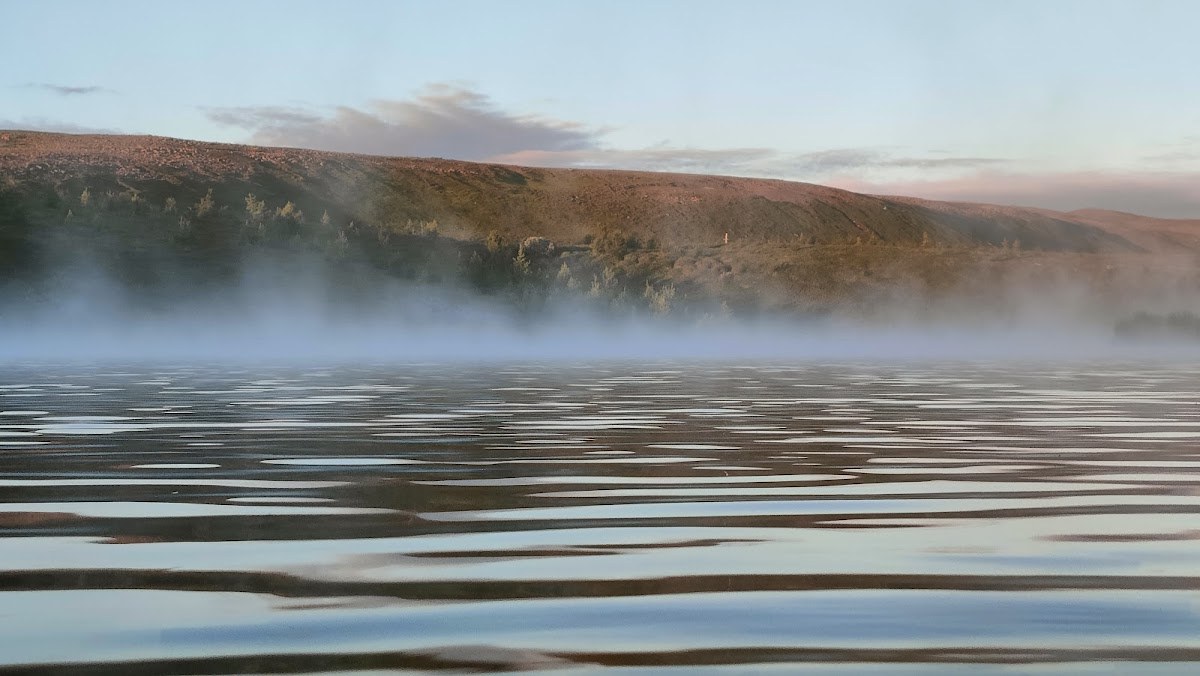 Low steam moving across the surface of the Geothermal Goldfish Pond near Kaldbakstjarnir.