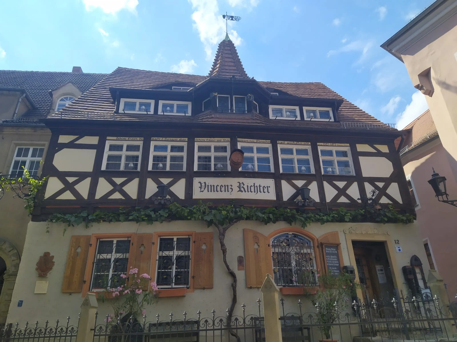Facade of the historic Vincenz Richter restaurant in Meissen, a half-timbered building with a tiled roof and a small turret.