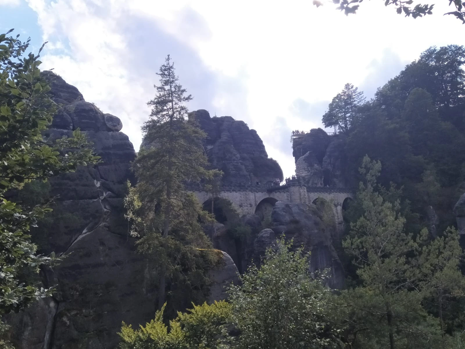 The Bastei Bridge, a stone arched bridge, set among the tall sandstone rock formations of Saxon Switzerland.
