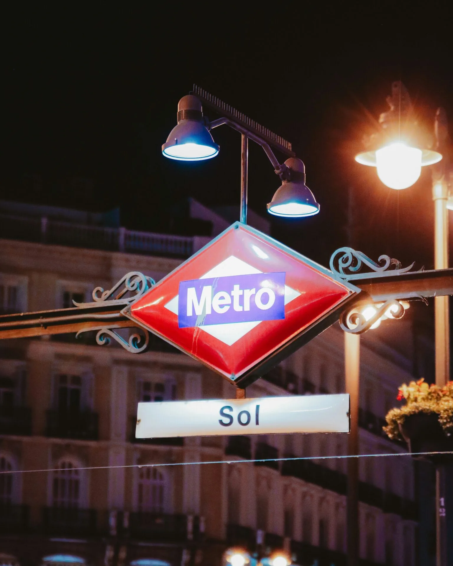 People waiting at a public transport stop in Madrid during the day