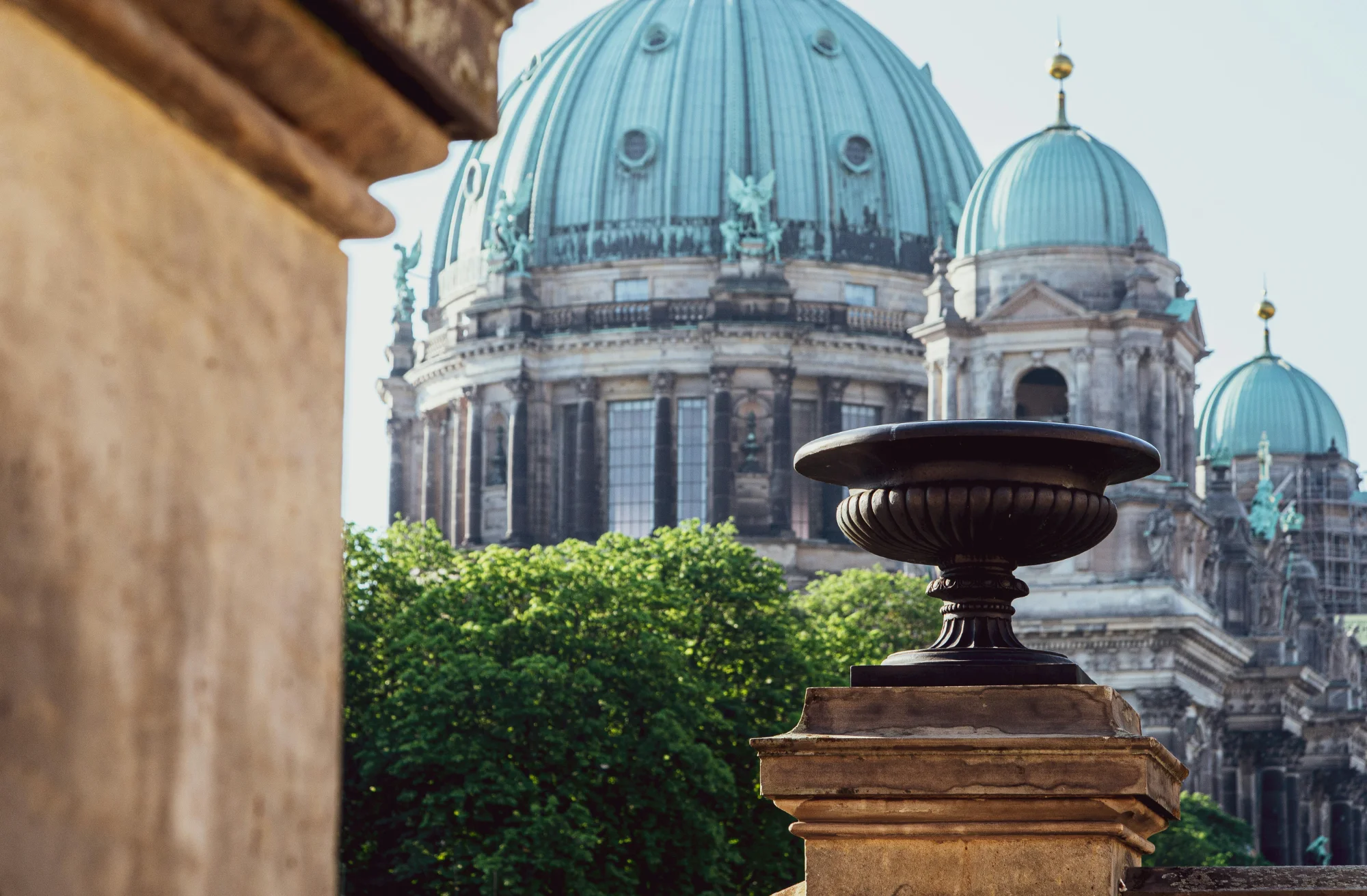 The turquoise domes of the Berlin Dome seen from the Old Museum