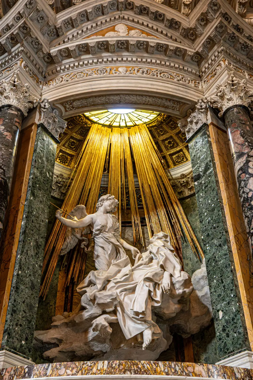 Bernini's marble sculpture of Saint Teresa and an angel under golden rays in the Cornaro Chapel.