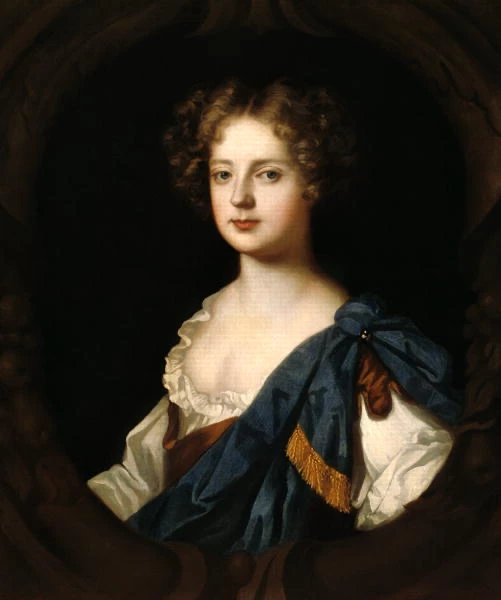 XVII-wieczny portret Nell Gwynne, młodej kobiety o jasnej cerze i kręconych brązowych włosach, w ozdobnej owalnej ramie.