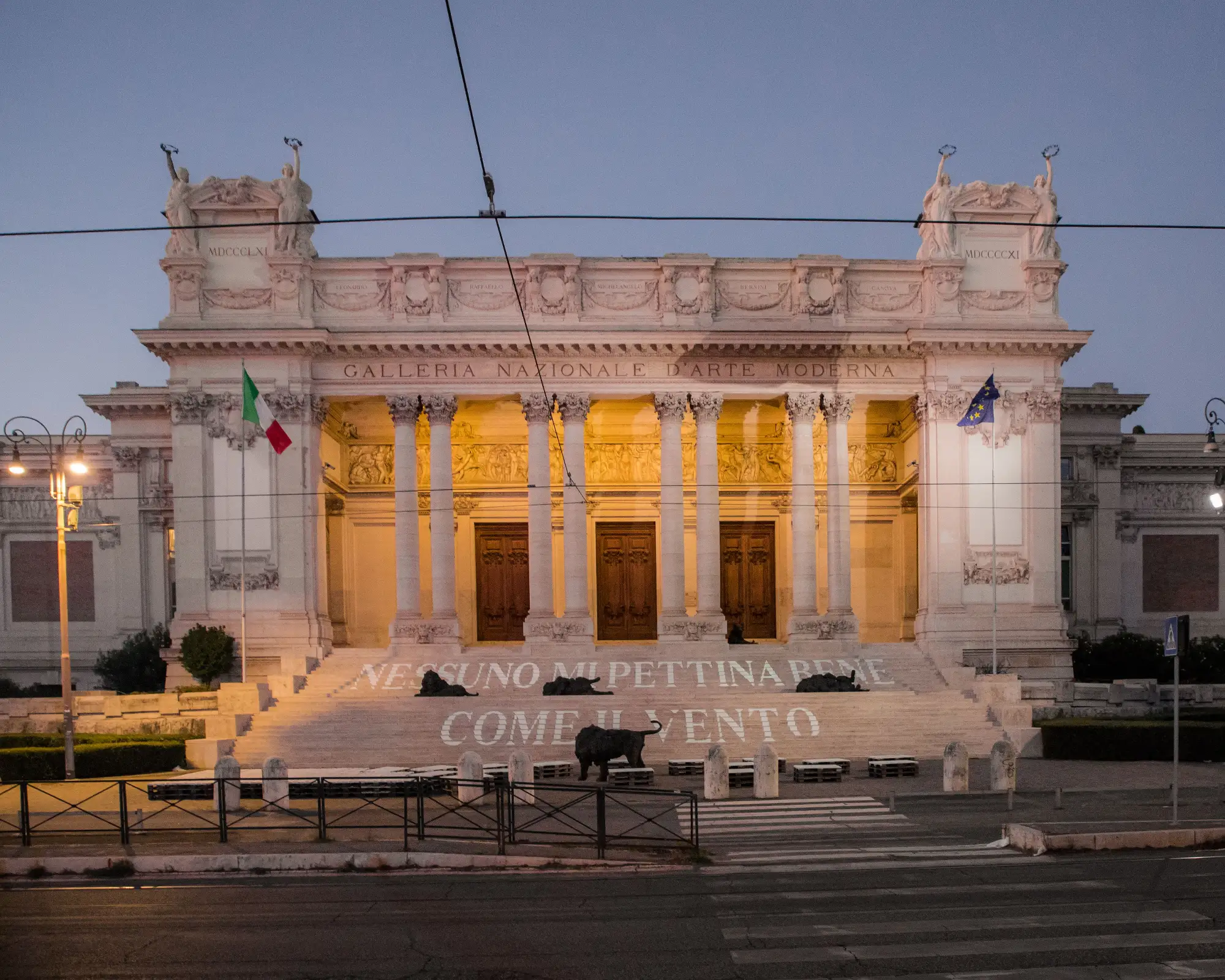 The grand, illuminated facade of the National Gallery of Modern Art in Rome at dusk.