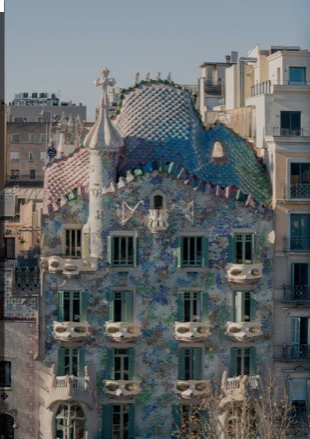 The colourful mosaic facade of Gaudí's Casa Batlló in Barcelona, with its tiled, dragon-like roof.