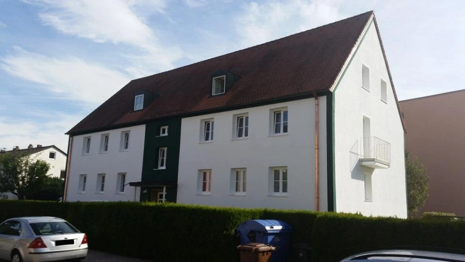 Energetisch saniertes Mehrfamilienhaus mit weißer Fassade und rotem Dach in der Goethestraße 20 in Plattling